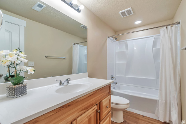 13038 Tower Ridge Drive Riverton, UT 84096 - Photo 18 of 30 Bathroom featuring a vanity with a white countertop and wood-finish cabinetry