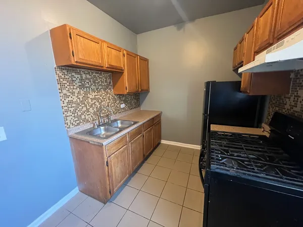 a kitchen with stainless steel appliances granite countertop a stove and a refrigerator