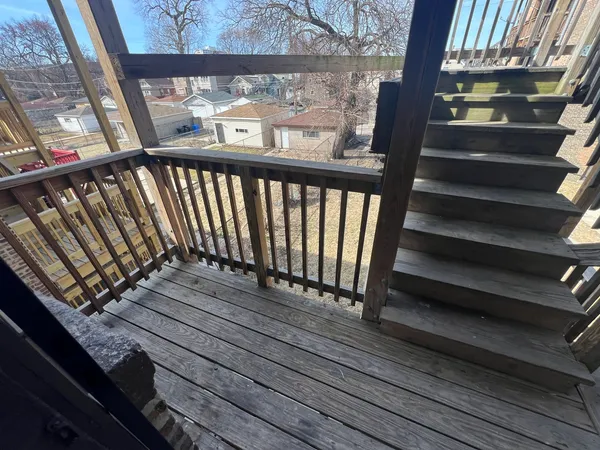 a view of a balcony with wooden floor
