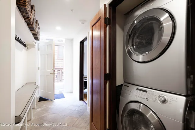a view of a hallway with washer and dryer