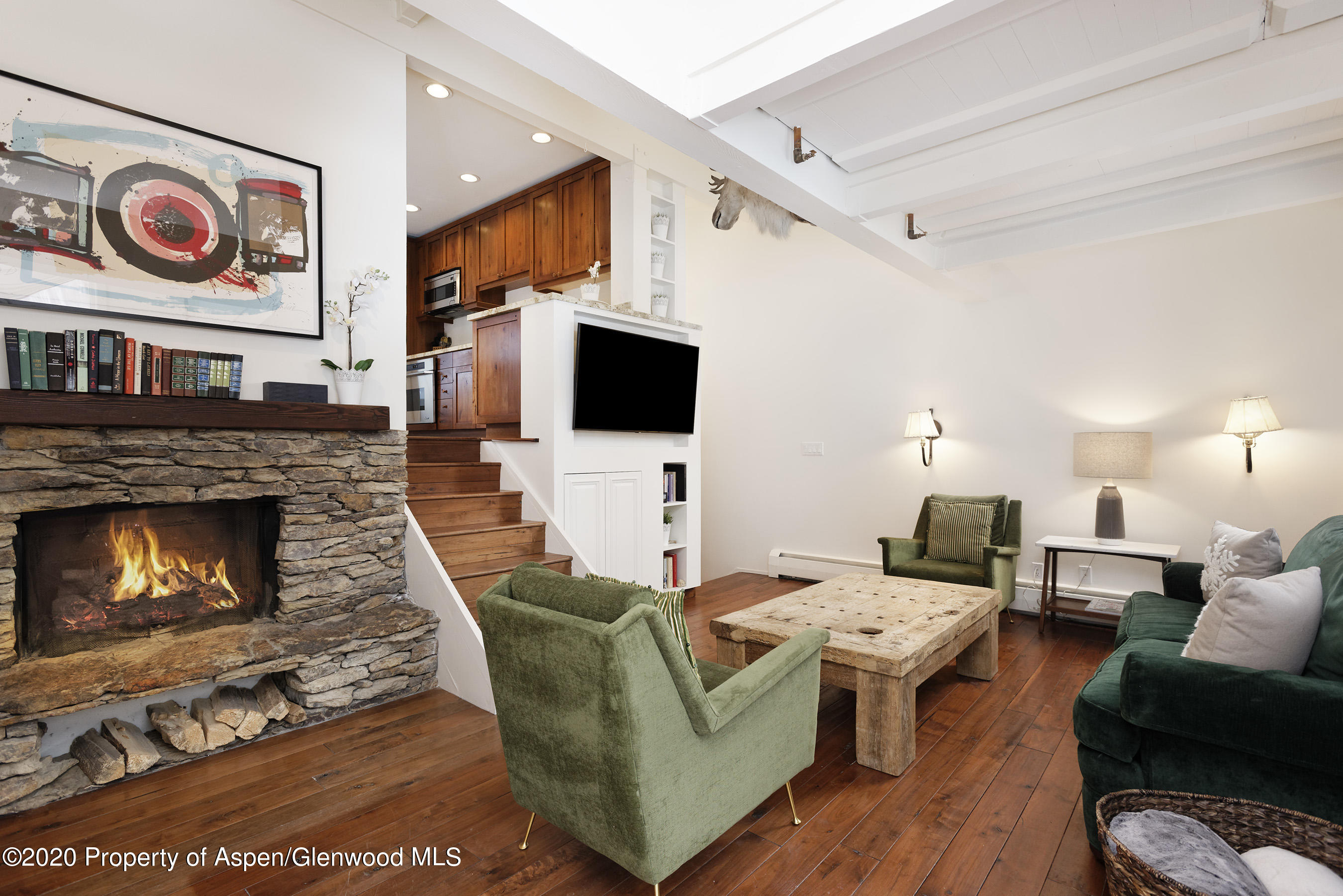 900 East Durant Avenue, Unit E114 Aspen, CO 81611 - Photo 2 of 13 a living room with furniture and a fireplace