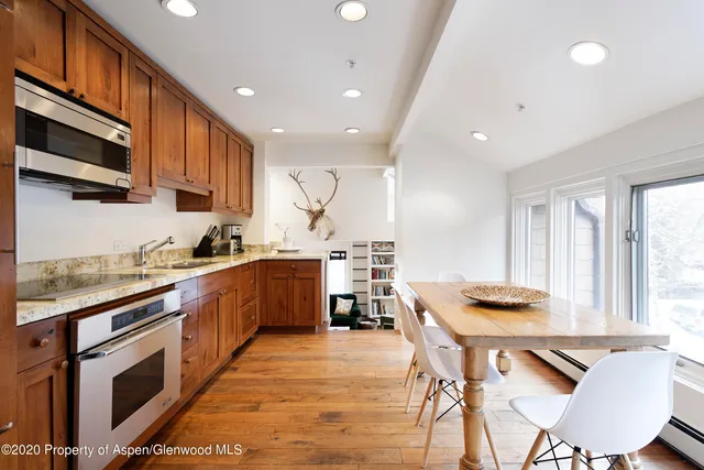 a kitchen with stainless steel appliances kitchen island granite countertop a sink and cabinets