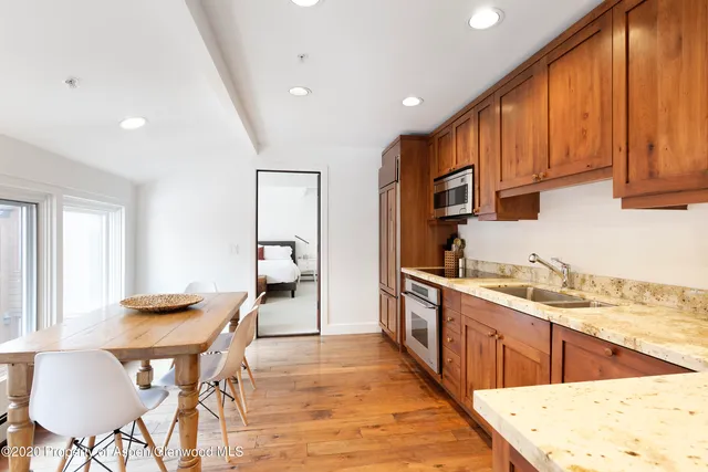 a kitchen with stainless steel appliances kitchen island granite countertop a sink and cabinets