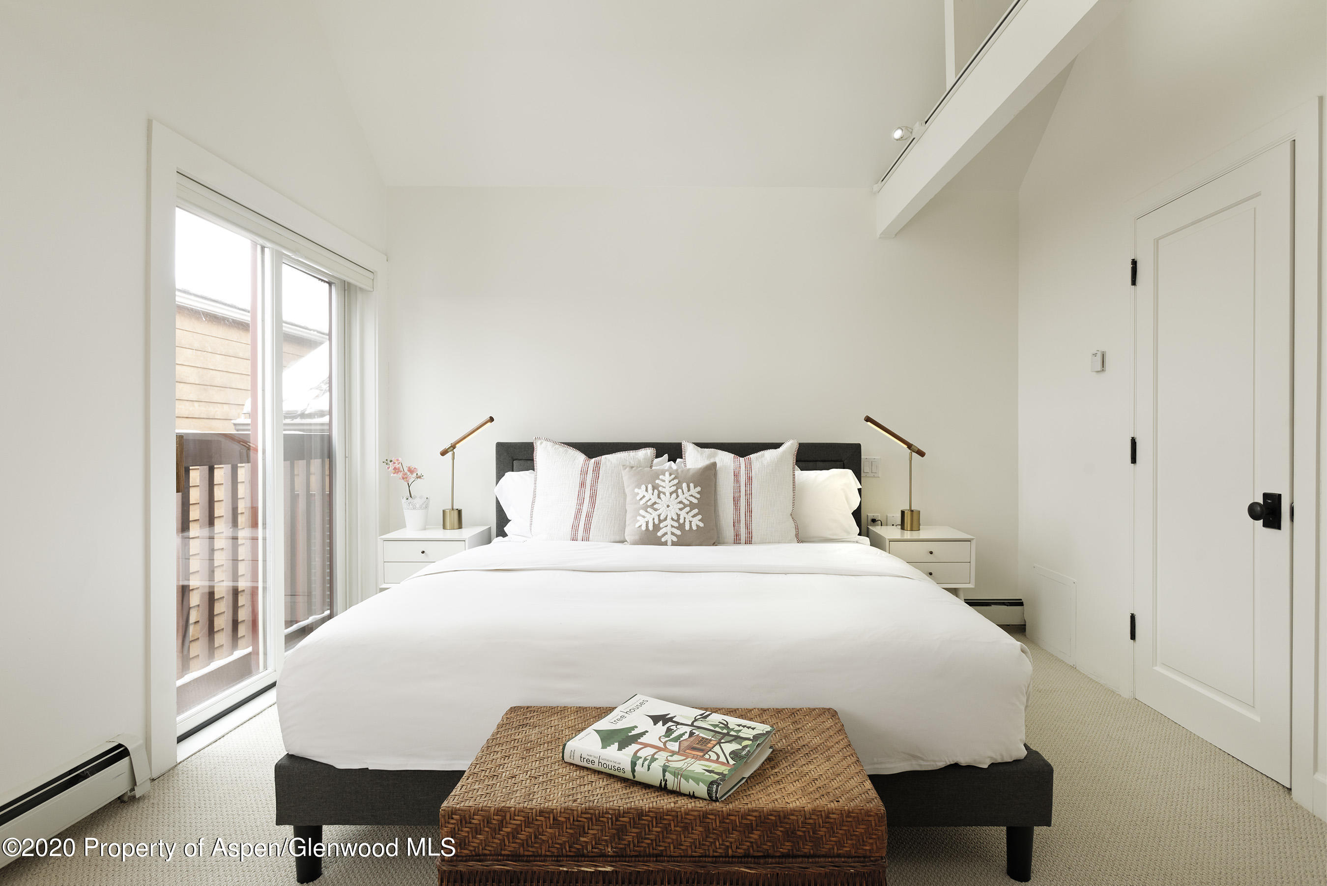 900 East Durant Avenue, Unit E114 Aspen, CO 81611 - Photo 6 of 13 a bedroom with a bed and a large window