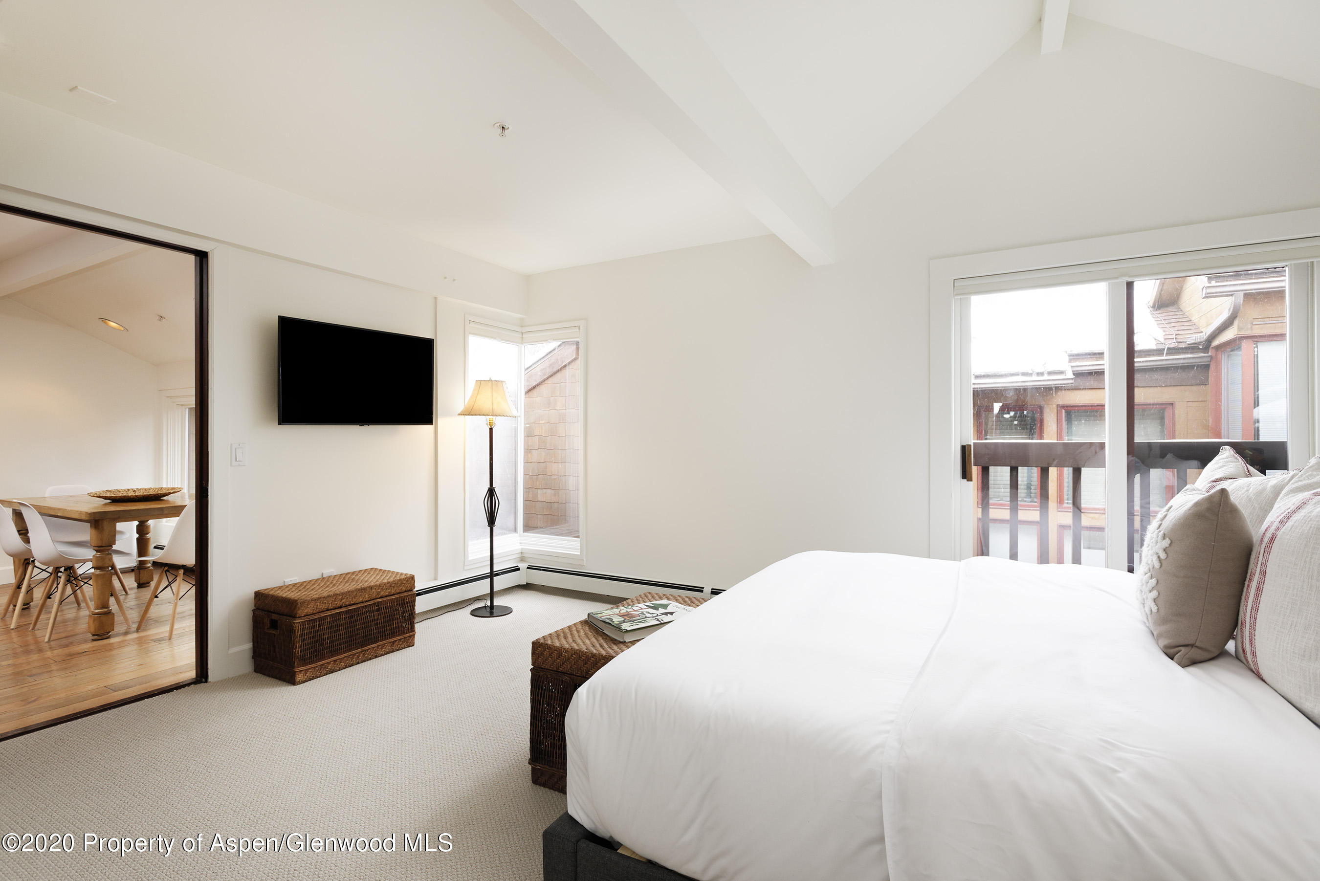 900 East Durant Avenue, Unit E114 Aspen, CO 81611 - Photo 7 of 13 a bedroom with a bed and large window