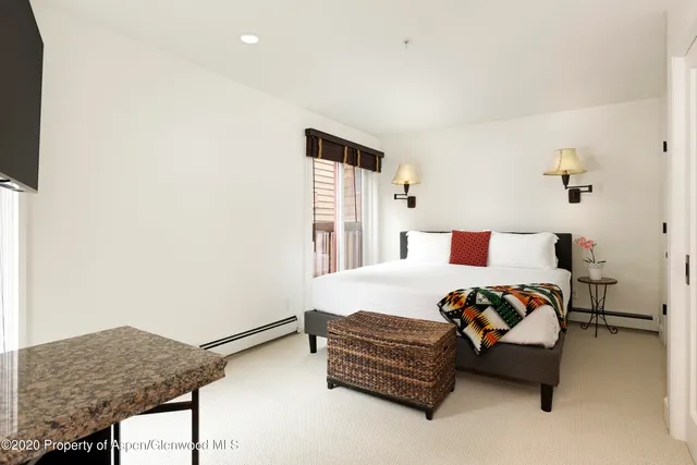 a bedroom with bed and window