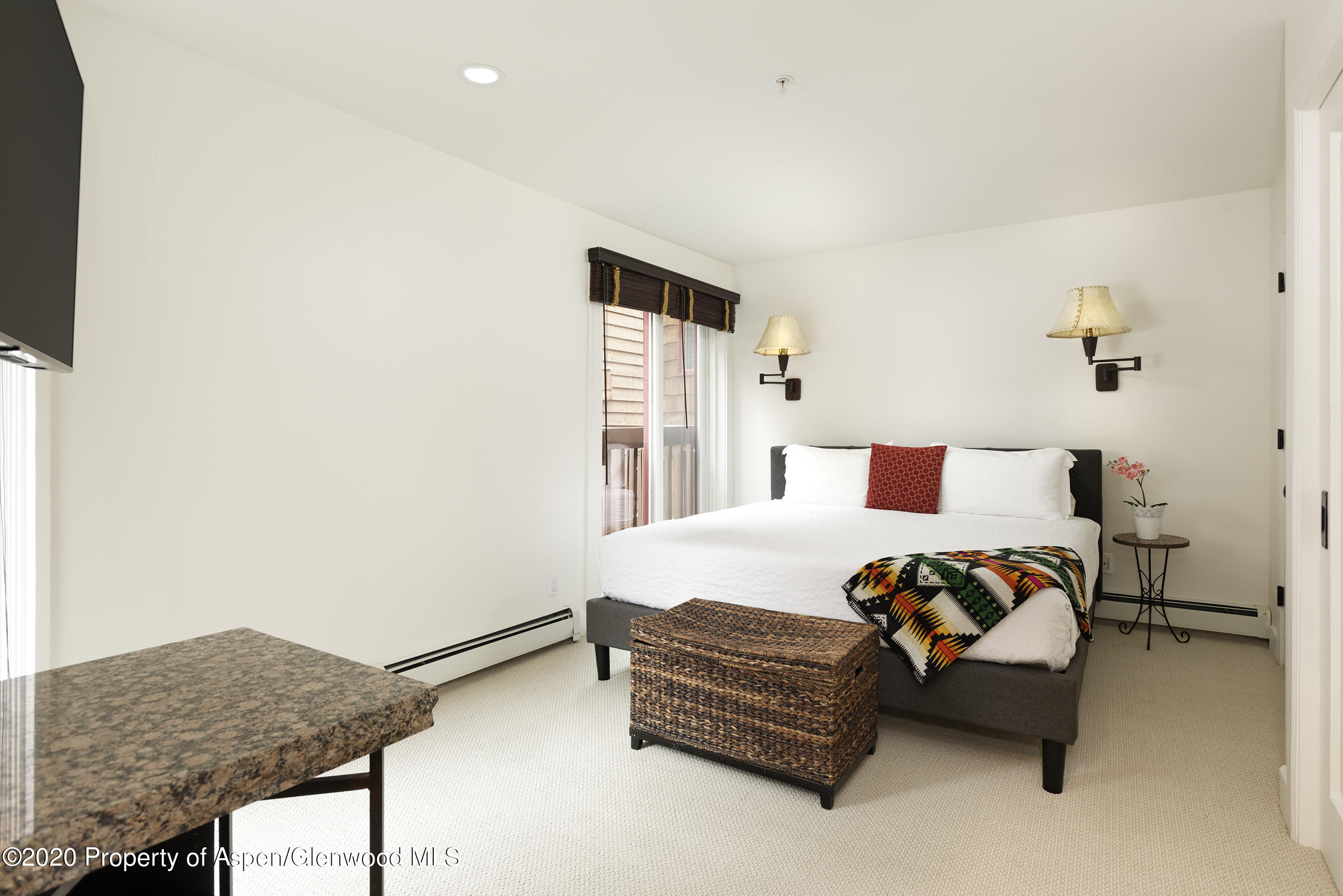 900 East Durant Avenue, Unit E114 Aspen, CO 81611 - Photo 10 of 13 a bedroom with bed and window