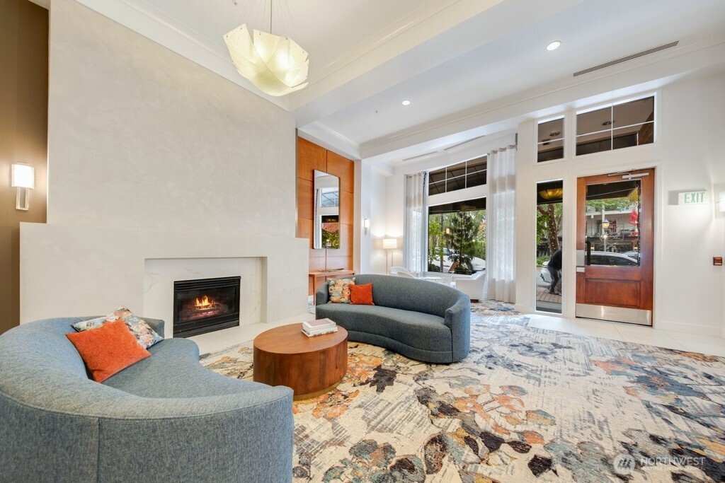 10042 Main Street, Unit 203 Bellevue, WA 98004 - Photo 13 of 30 a living room with furniture and a fireplace