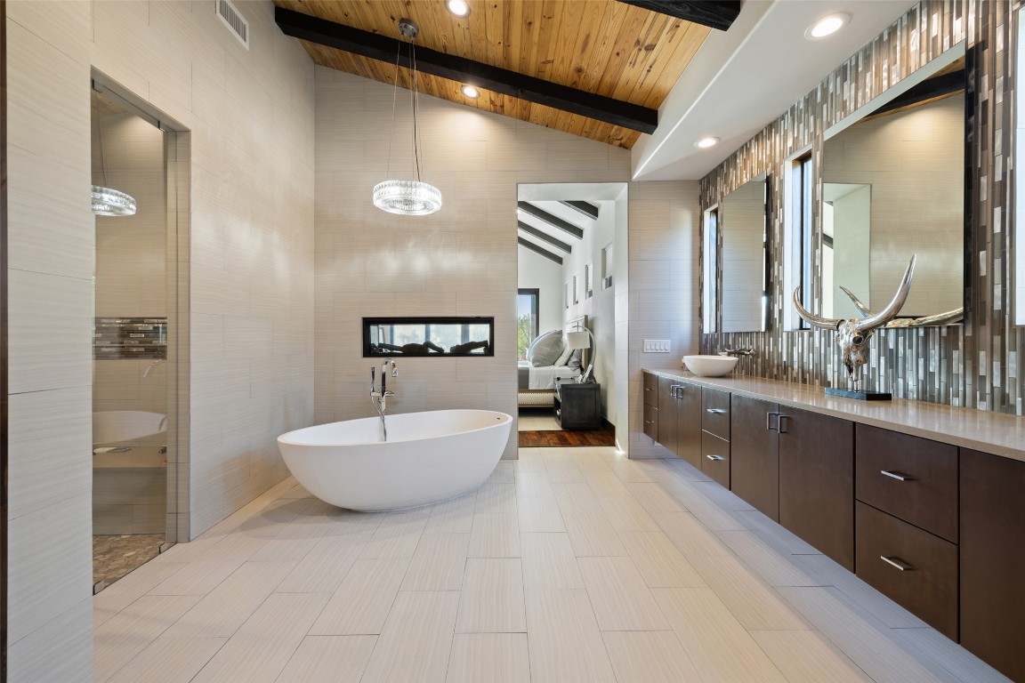 101 Rolling Hills Road Blanco, TX 78606 - Photo 12 of 38 a spacious bathroom with a double vanity sink and a mirror