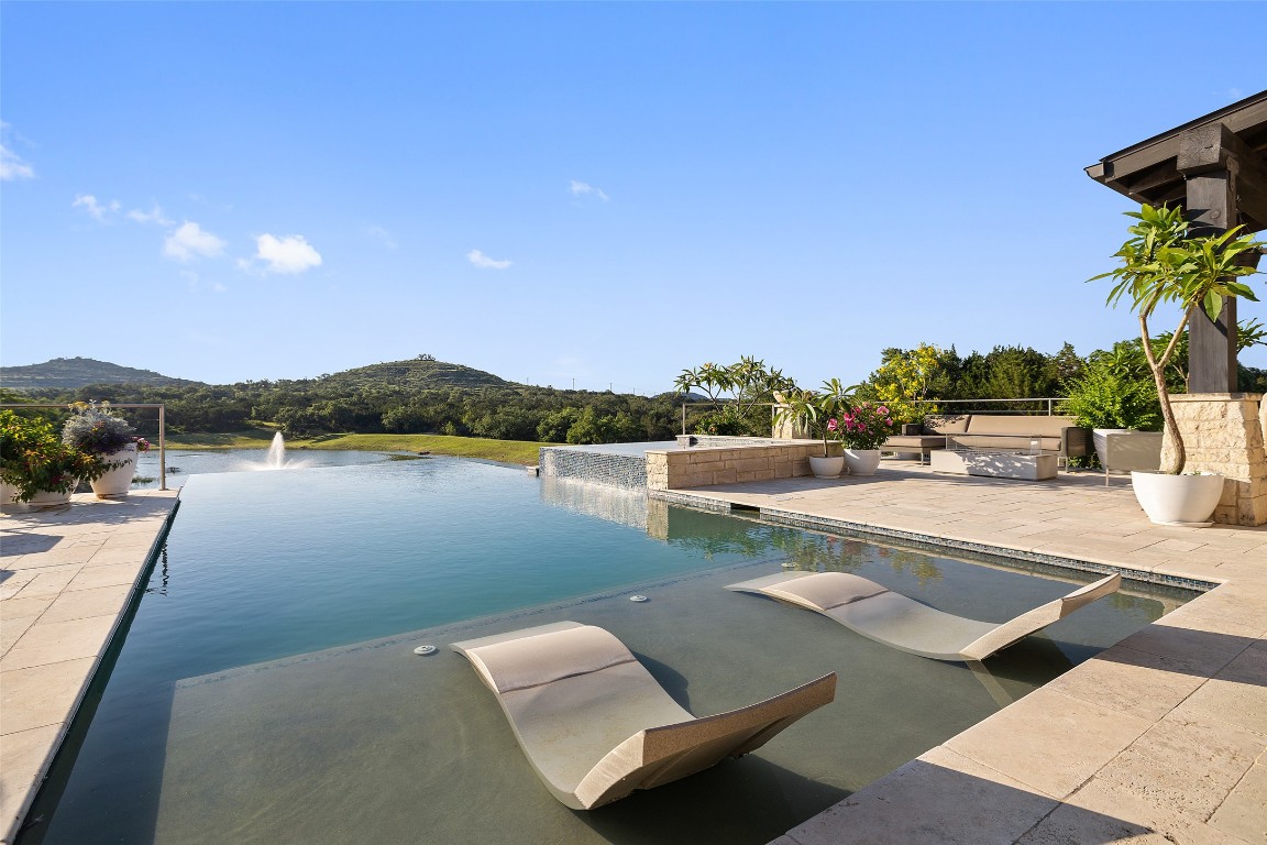 101 Rolling Hills Road Blanco, TX 78606 - Photo 15 of 38 a view of swimming pool with seating area and lake view
