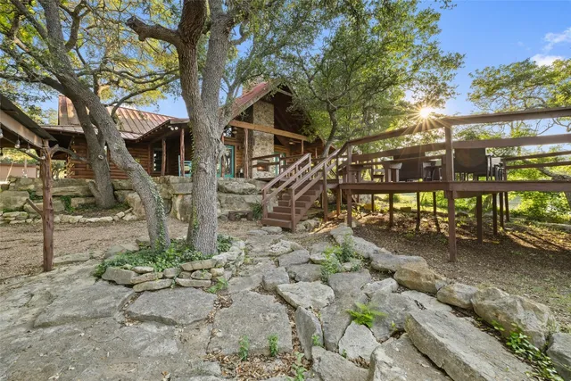 a view of a chairs and table in the backyard