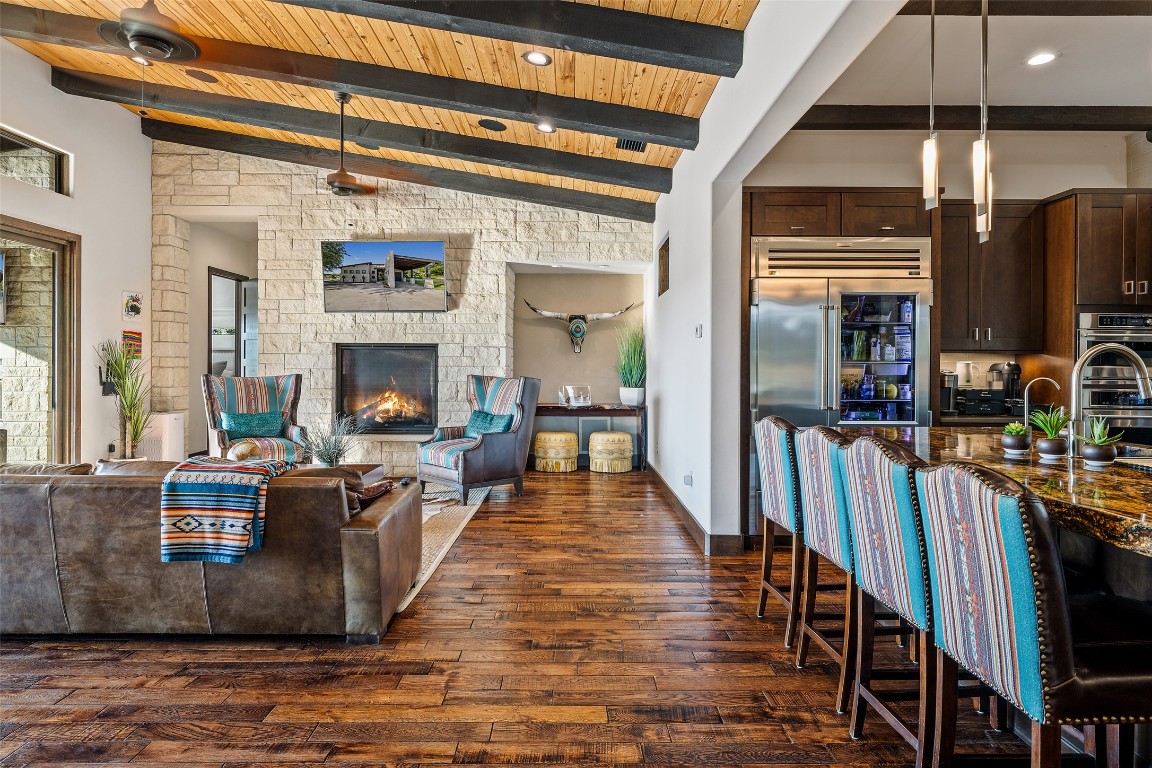 101 Rolling Hills Road Blanco, TX 78606 - Photo 5 of 38 a living room with furniture a fireplace and a floor to ceiling window
