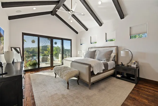 a bedroom with a bed and large window