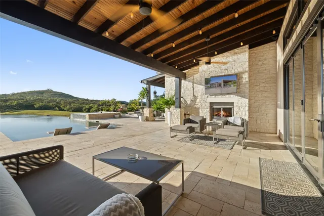 a view of a patio with swimming pool table and chairs