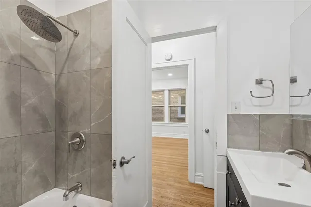 a bathroom with a sink a mirror and shower