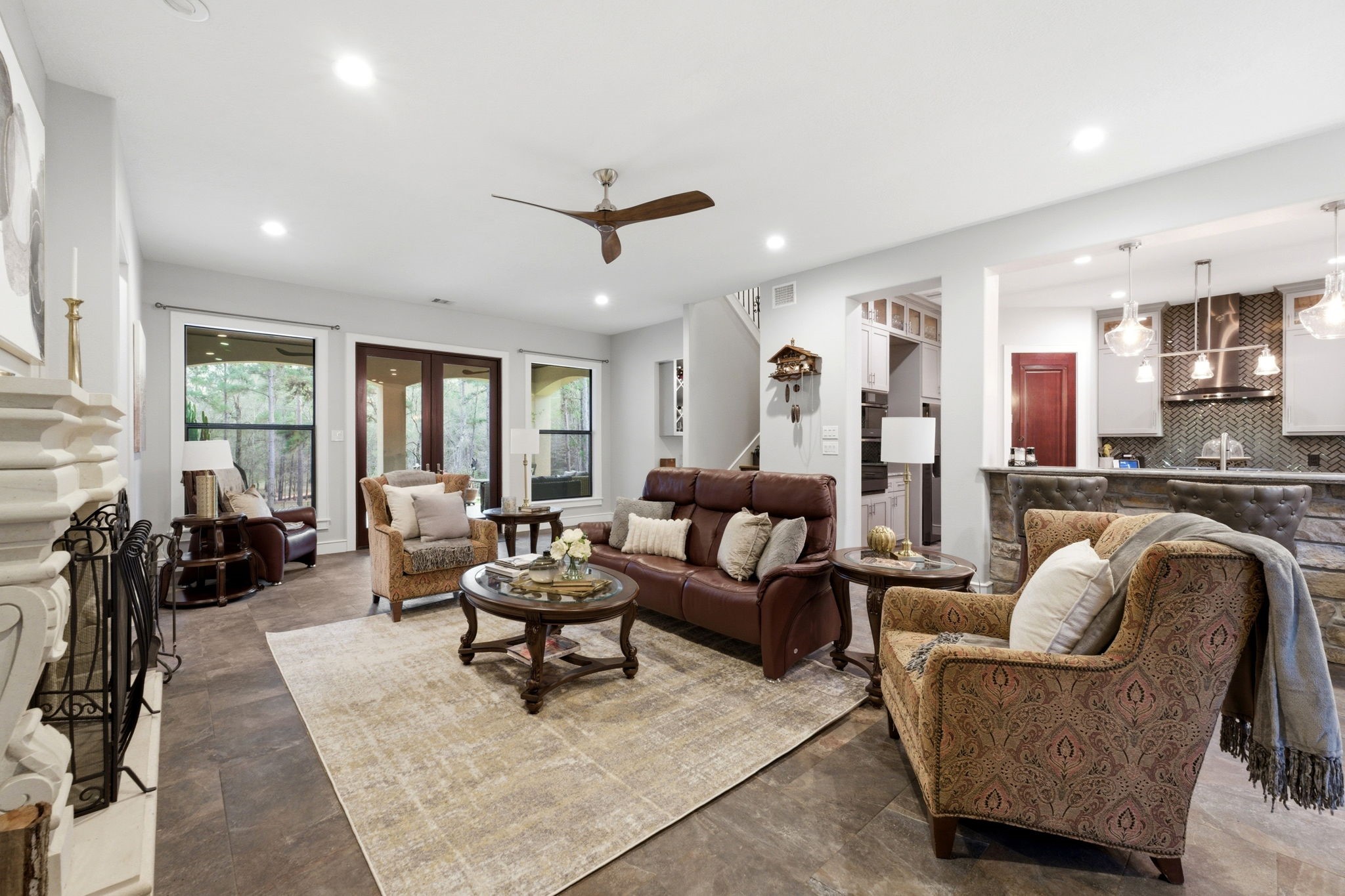 280 Sundog Road Huntsville, TX 77340 - Photo 12 of 50 Another view of the family room showcasing French doors that open to the patio and backyard, filling the space with natural light and connecting indoor and outdoor living.
