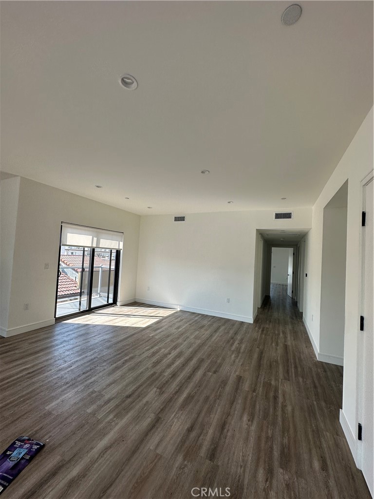 325 Myrtle Street, Unit 301 Glendale, CA 91203 - Photo 11 of 28 a view of an empty room with wooden floor and a window