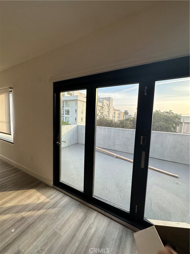 325 Myrtle Street, Unit 301 Glendale, CA 91203 - Photo 12 of 28 an empty room with wooden floor and windows