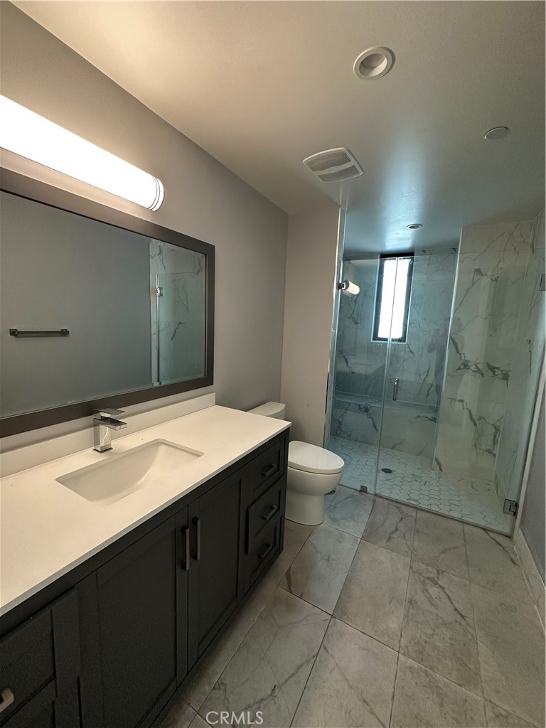 325 Myrtle Street, Unit 301 Glendale, CA 91203 - Photo 15 of 28 a bathroom with a sink a toilet and shower