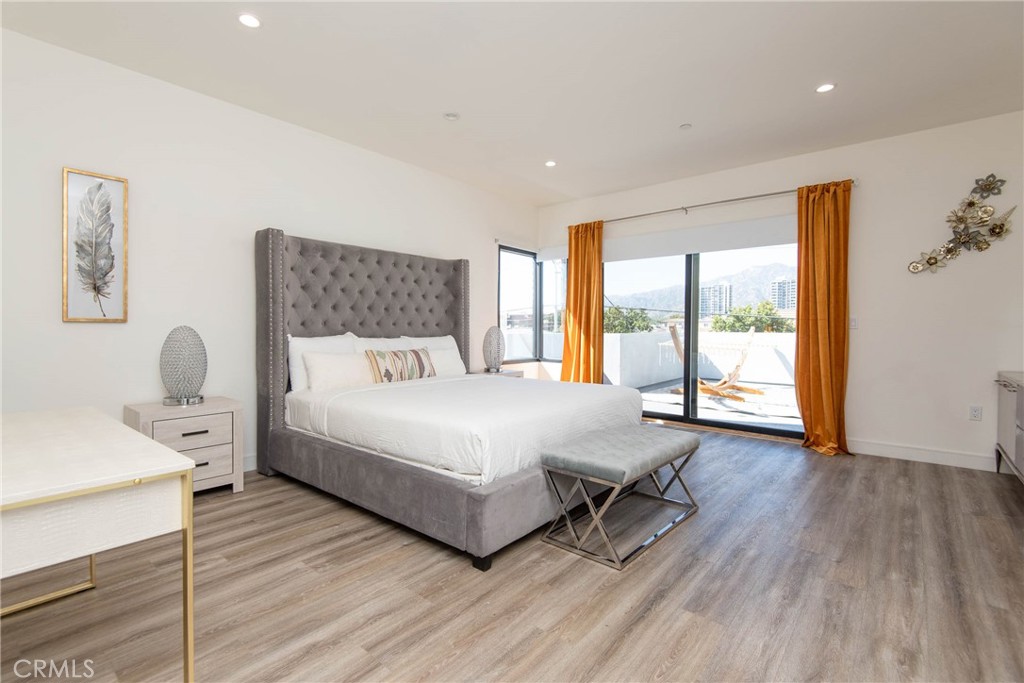 325 Myrtle Street, Unit 301 Glendale, CA 91203 - Photo 16 of 28 a bedroom with a bed and wooden floor