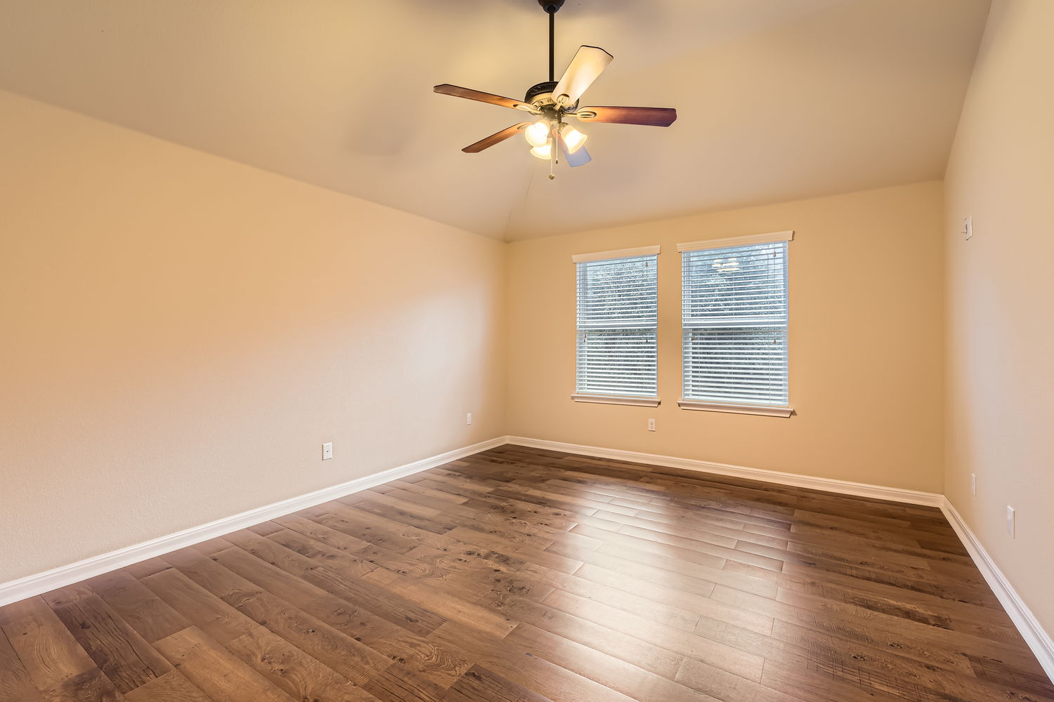 547 Stone View Trail, Unit 112 Austin, TX 78737 - Photo 12 of 28 an empty room with wooden floor fan and windows