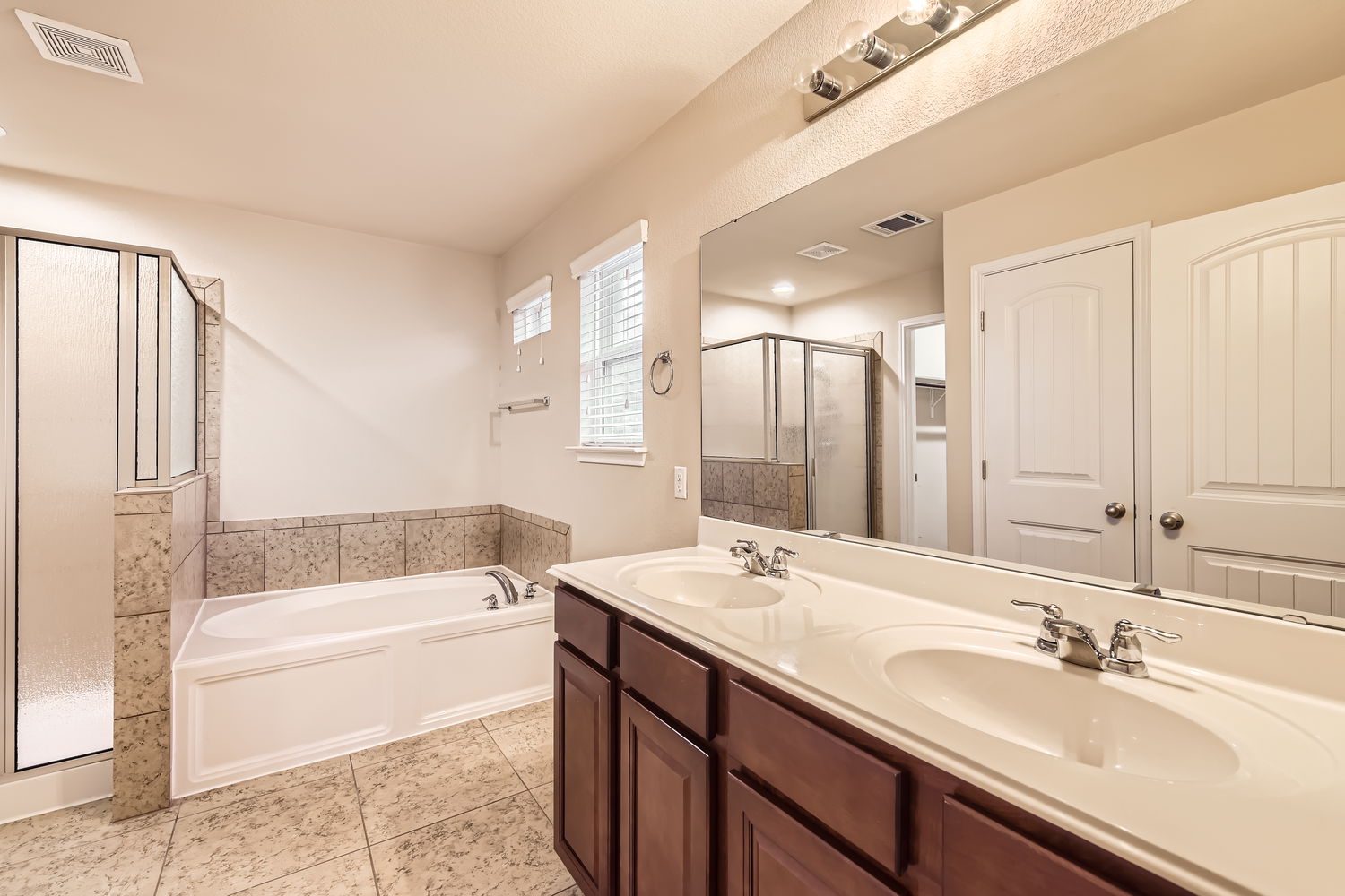 547 Stone View Trail, Unit 112 Austin, TX 78737 - Photo 14 of 28 a bathroom with a tub double sink and mirror