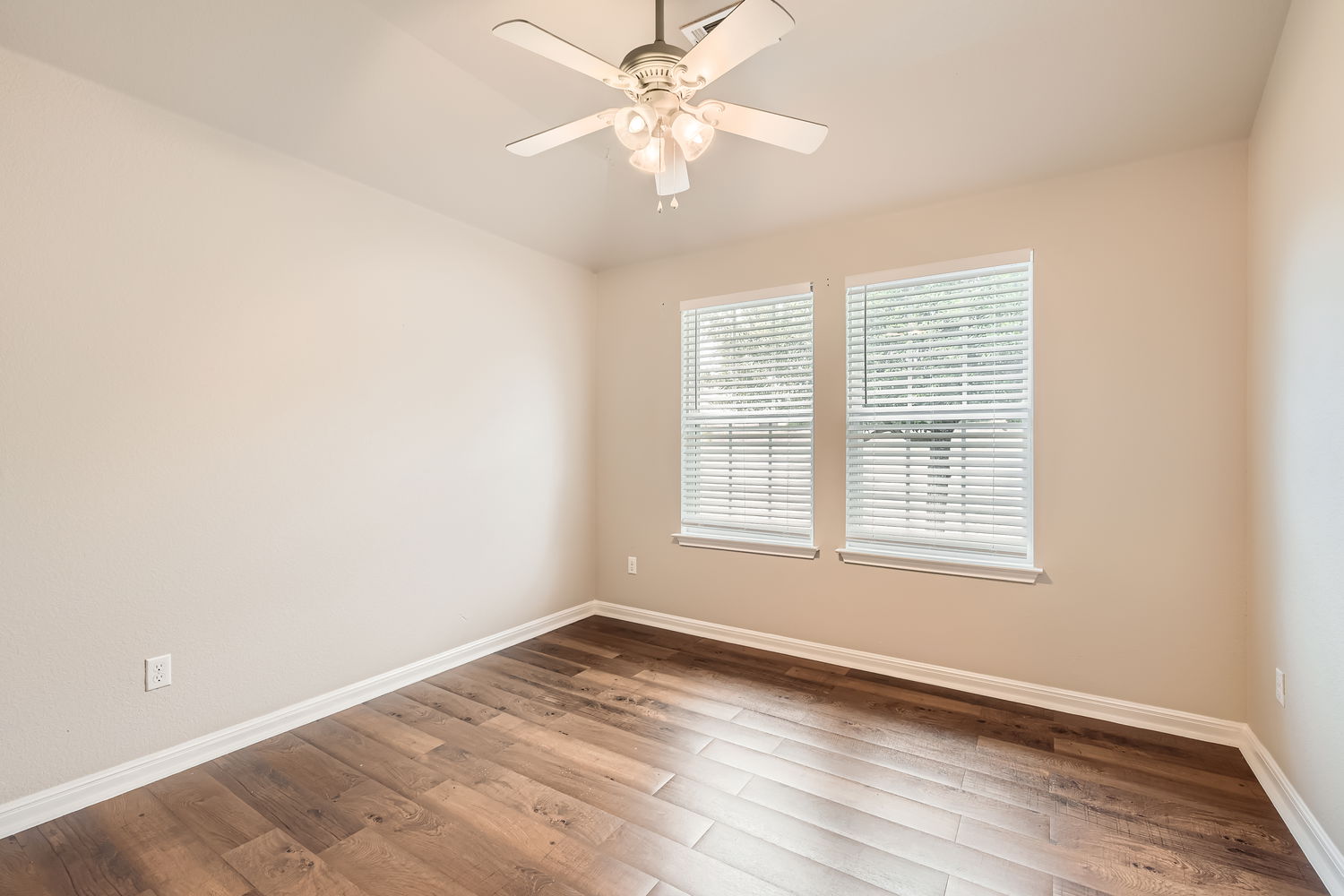 547 Stone View Trail, Unit 112 Austin, TX 78737 - Photo 17 of 28 an empty room with chandelier fan and windows