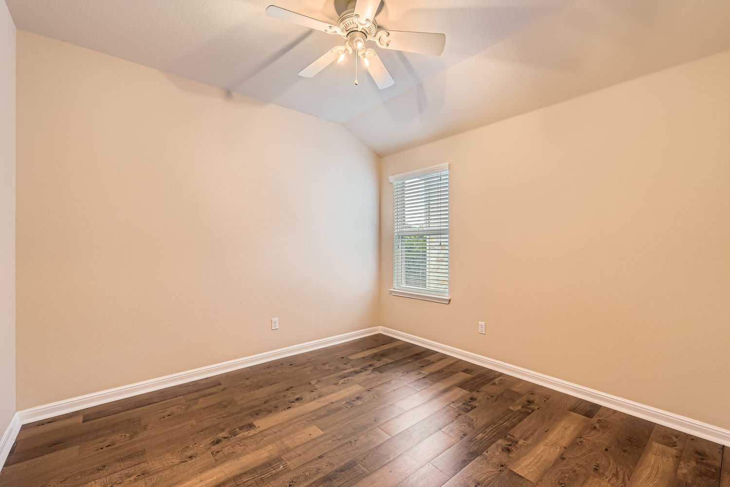 547 Stone View Trail, Unit 112 Austin, TX 78737 - Photo 19 of 28 an empty room with wooden floor and windows