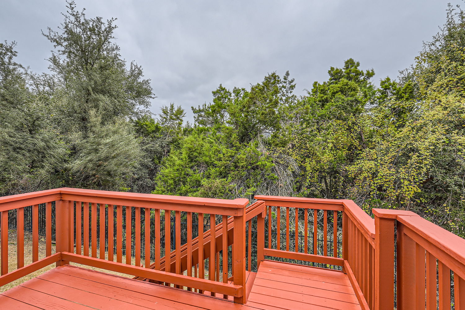 547 Stone View Trail, Unit 112 Austin, TX 78737 - Photo 24 of 28 a view of balcony with wooden floor and fence