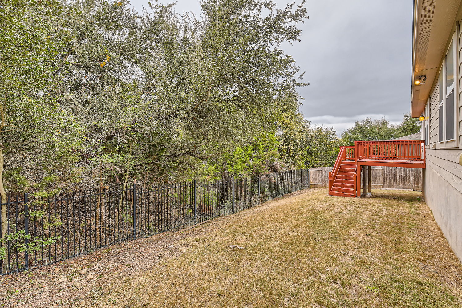 547 Stone View Trail, Unit 112 Austin, TX 78737 - Photo 25 of 28 a view of a yard with wooden fence