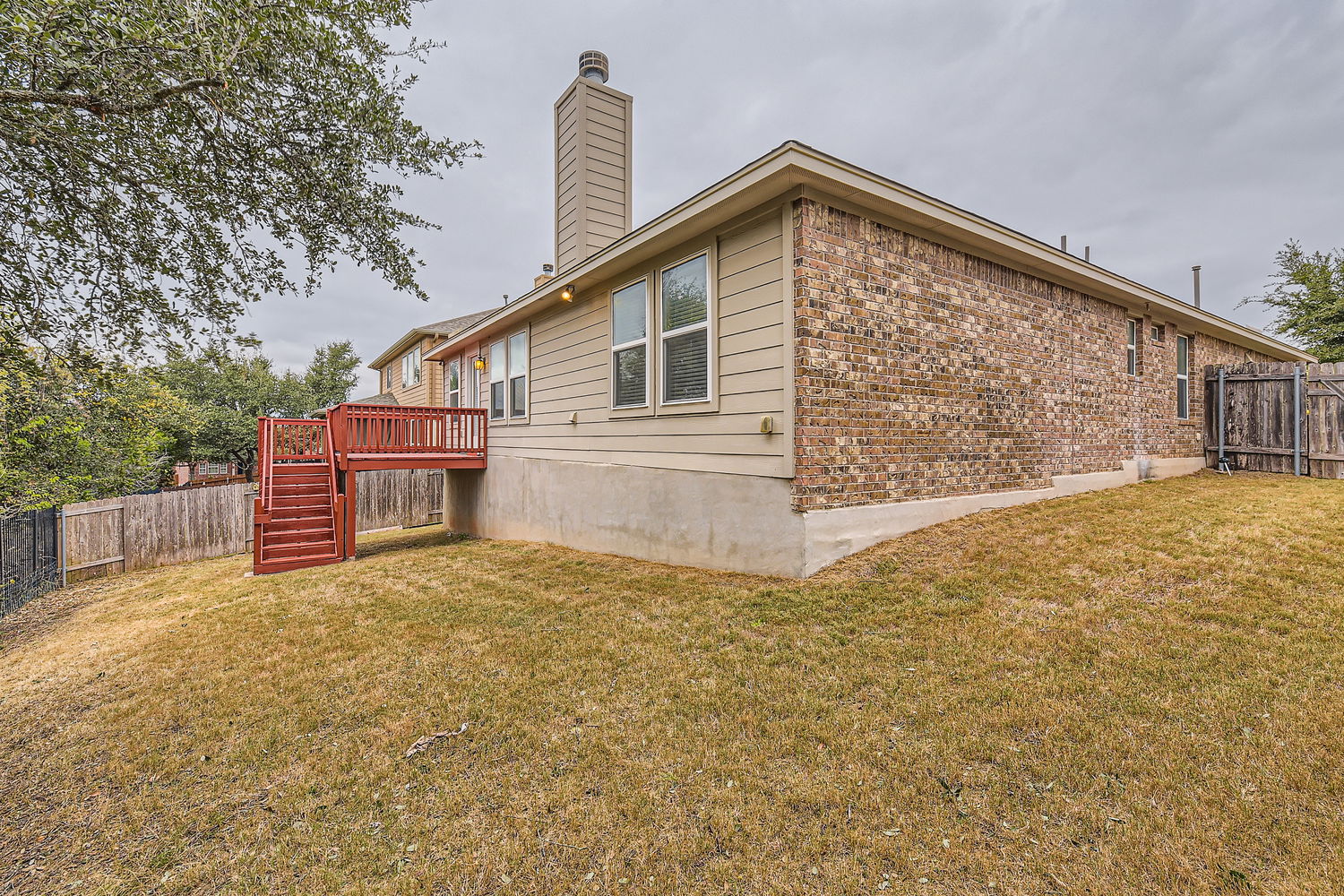 547 Stone View Trail, Unit 112 Austin, TX 78737 - Photo 26 of 28 a view of a house with a yard