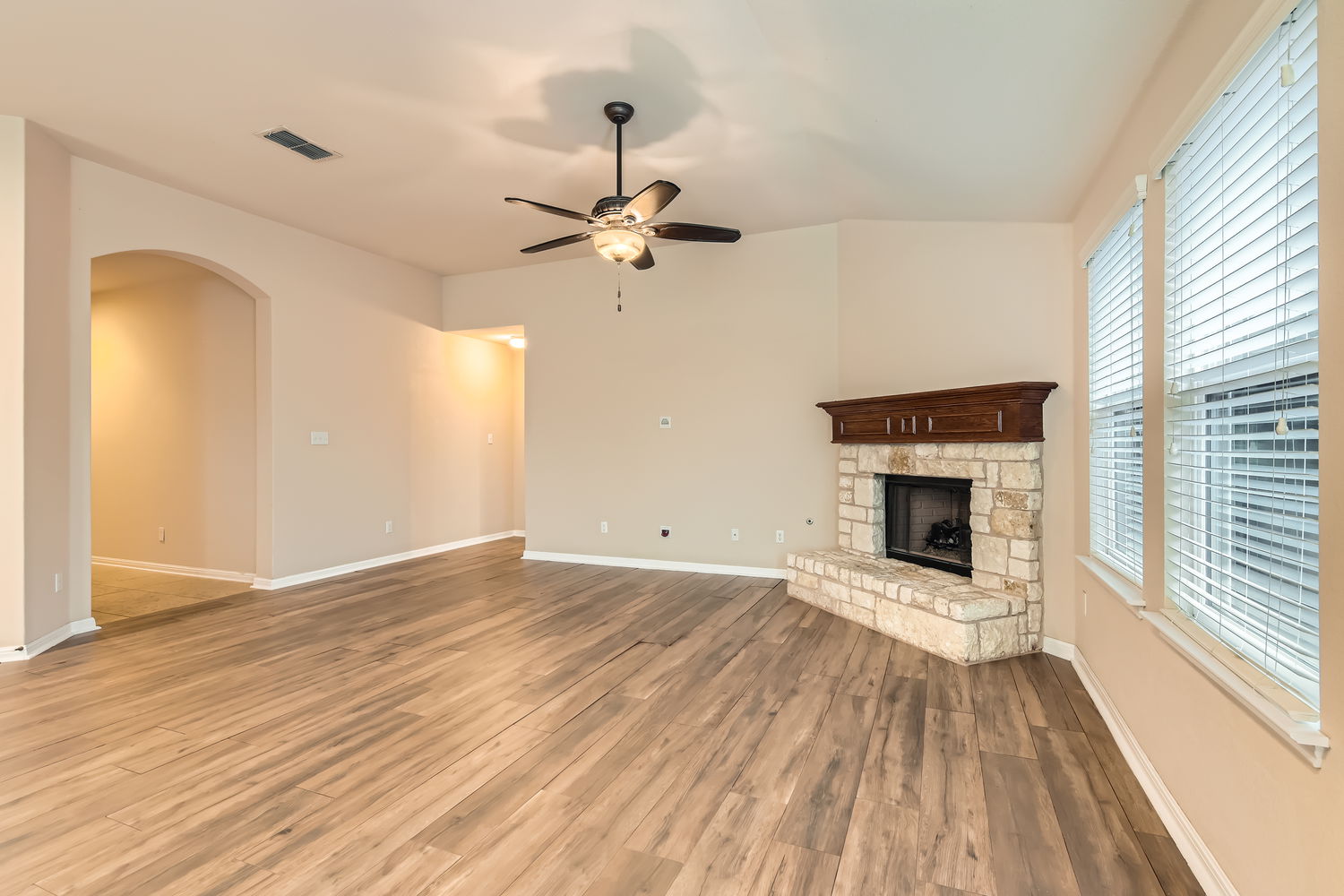 547 Stone View Trail, Unit 112 Austin, TX 78737 - Photo 6 of 28 wooden floor in an empty room with a fireplace