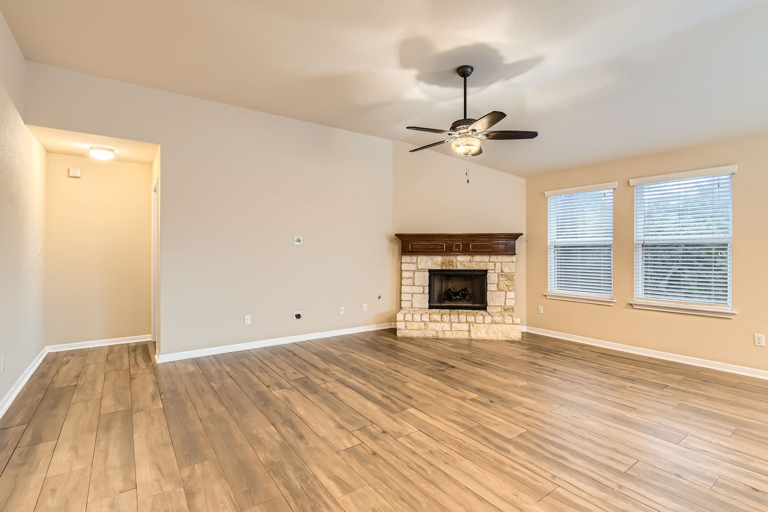 547 Stone View Trail, Unit 112 Austin, TX 78737 - Photo 7 of 28 a view of empty room with wooden floor and fan