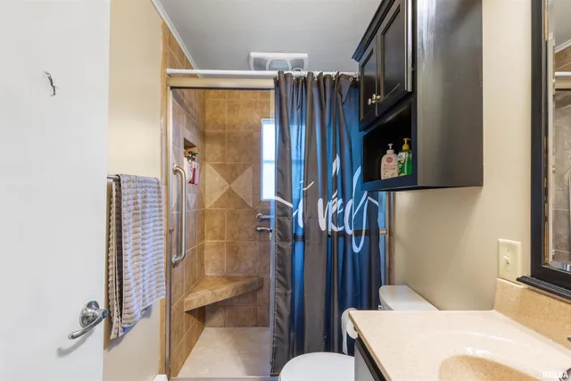 a bathroom with a sink toilet and shower