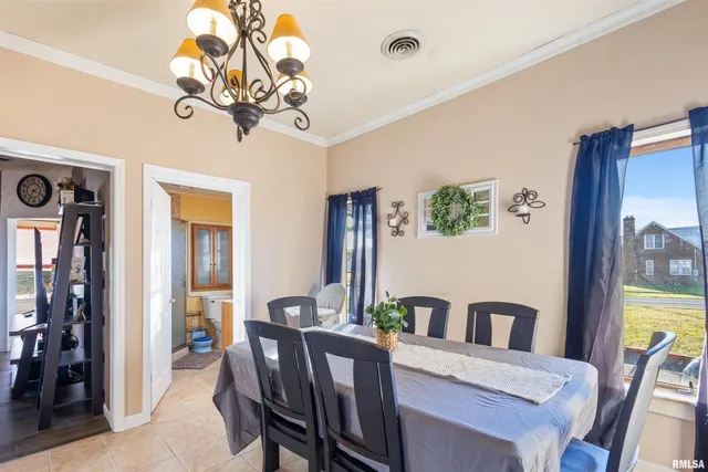 a view of a dining room with furniture and chandelier