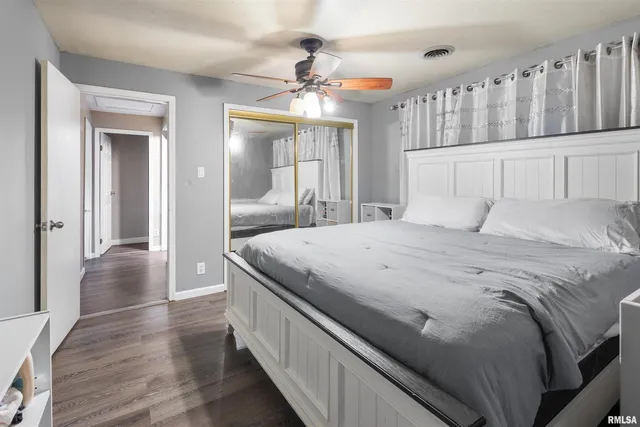 a spacious bedroom with a bed and a chandelier