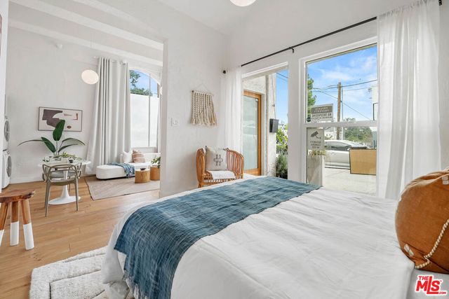 a bedroom with a bed a table and chair