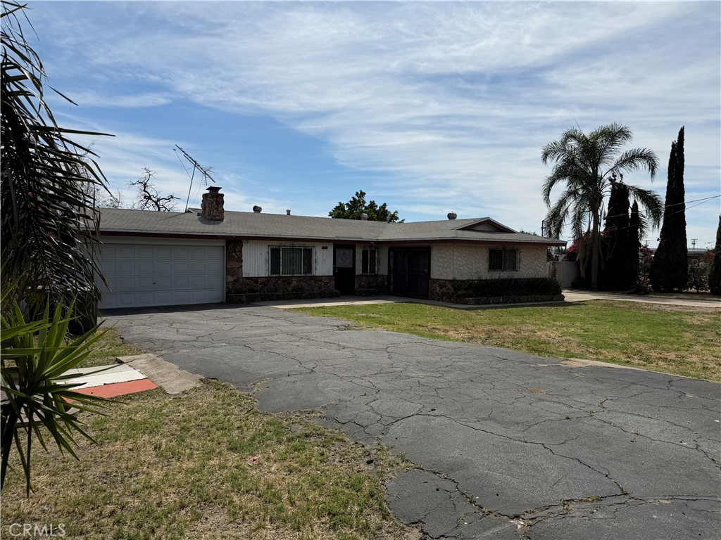 0 Boyle Fontana, CA 92337 - Photo 9 of 9 a view of a white house with a yard and potted plants