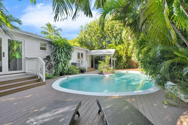 a view of house with swimming pool outdoor seating