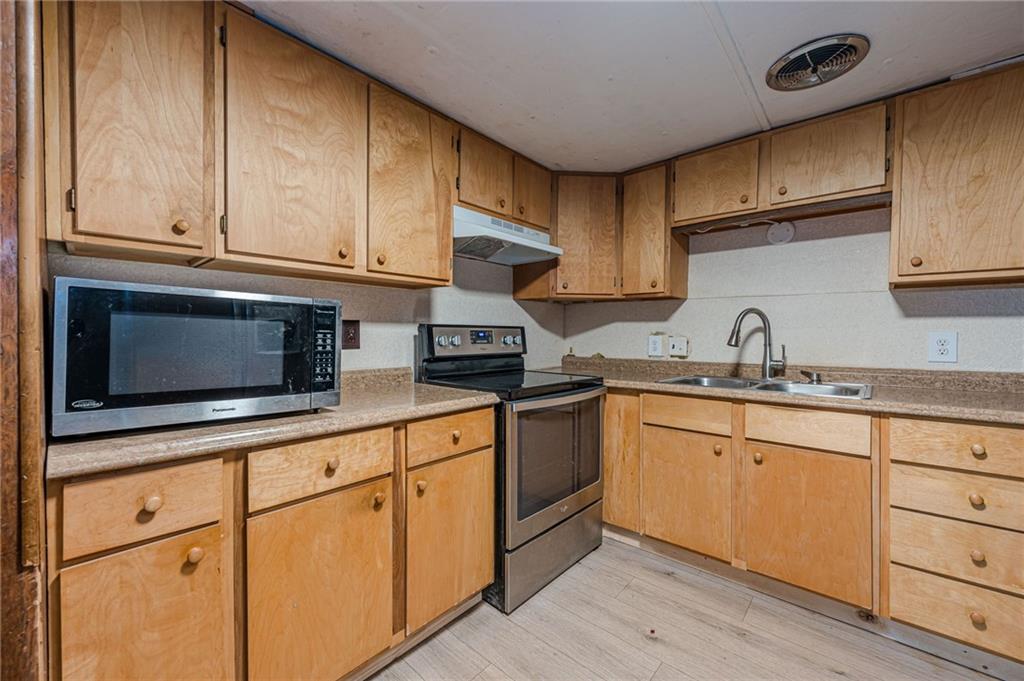 90 Valley Trail Southeast Acworth, GA 30101 - Photo 12 of 28 a kitchen with granite countertop cabinets stainless steel appliances and a sink