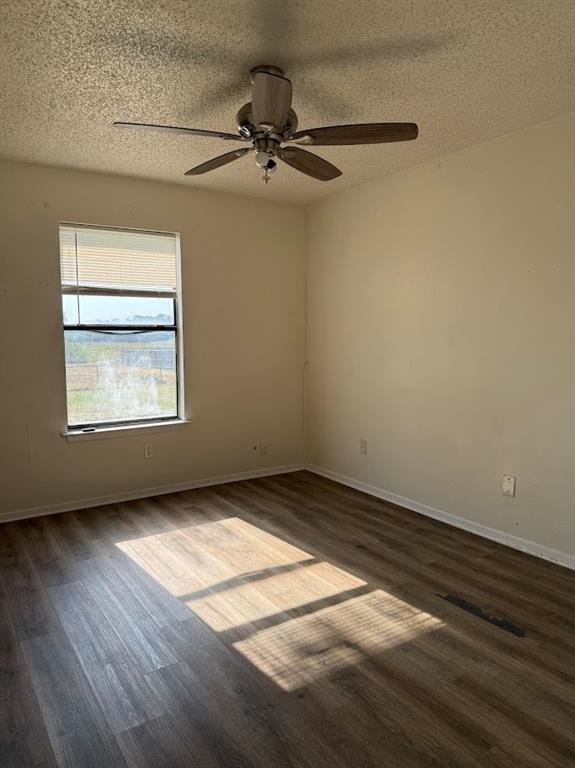 11204 Liberty School Road Pelican Bay, TX 76020 - Photo 12 of 23 an empty room with wooden floor chandelier fan and windows