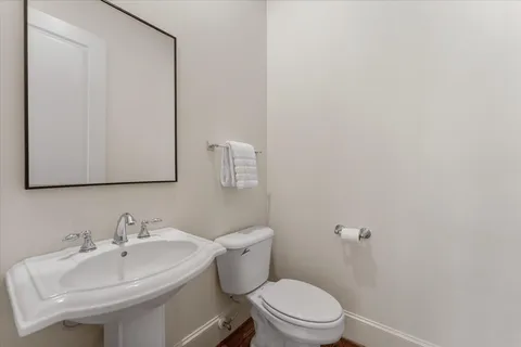 a white toilet sitting next to a bathroom sink