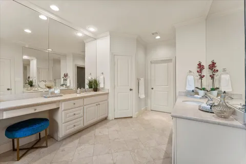 a spacious bathroom with a granite countertop sink a mirror and a bathtub
