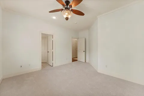 an empty room with a fan and a fan