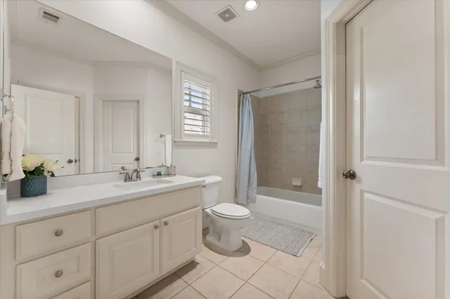 a bathroom with a double vanity sink toilet and shower