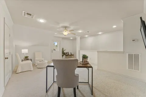a living room with furniture and a dining table