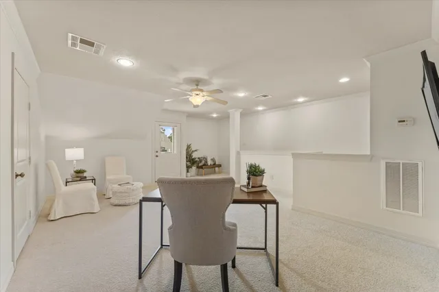 a living room with furniture and a dining table