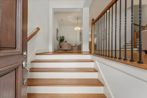 a view of staircase with white walls and a window