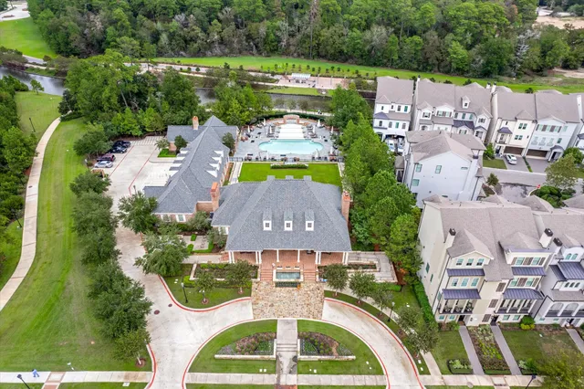 an aerial view of a house with swimming pool and garden