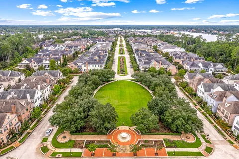 an aerial view of a residential apartment building with swimming pool and outdoor space